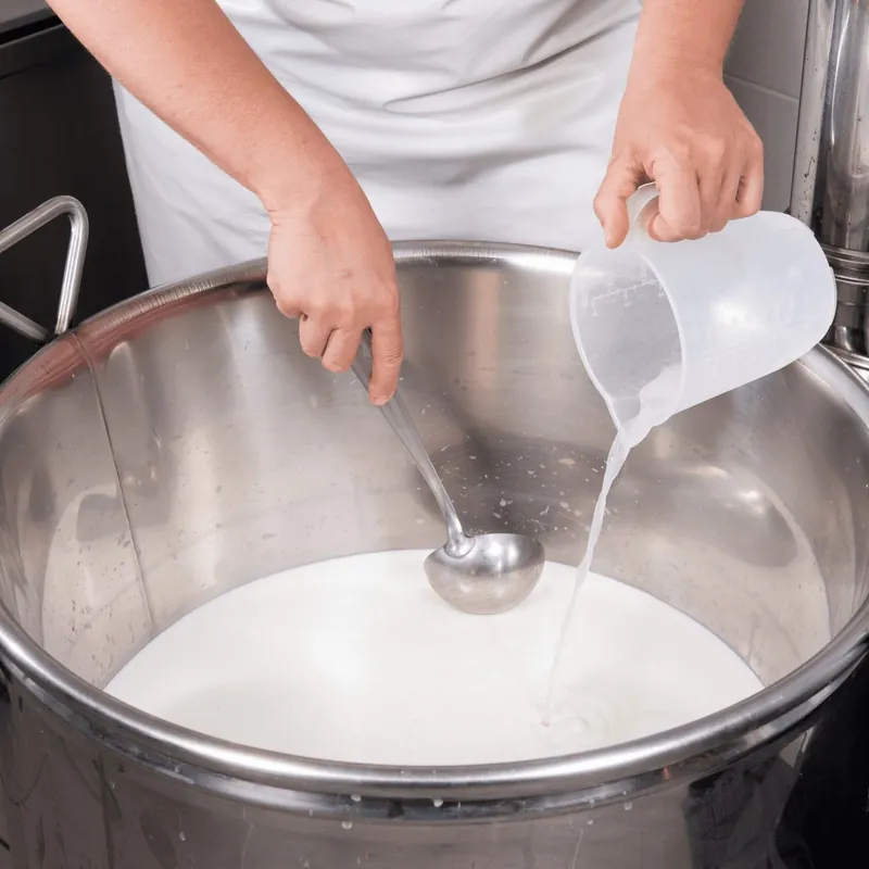 Curd being cut in the pot